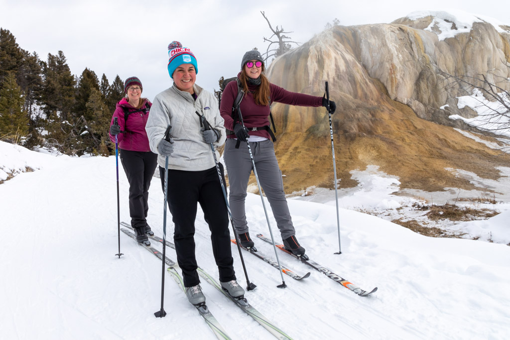 A group of cross-country skiers near Orange Spring Mound on the Mammoth Hot Springs Terraces in Yellowstone.