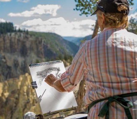An artist sketches on a summer day at the Grand Canyon of the Yellowstone.
