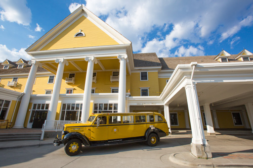 Lake Yellowstone Hotel with historic Yellowstone bus. NPS / Neal Herbert