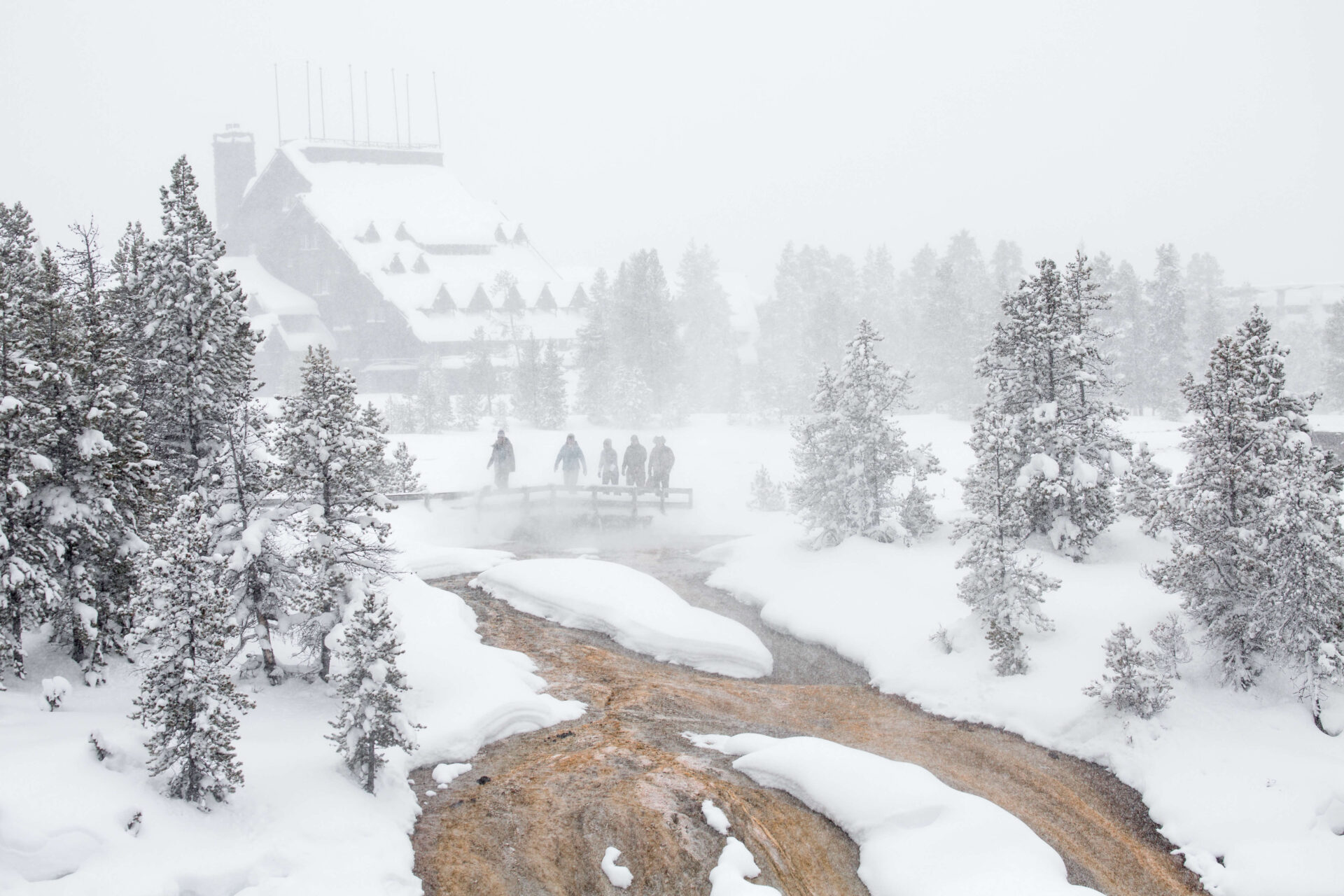 exploring-the-boardwalks-at-old-faithful-in-a-blizzard-nps-neal-herbert-yellowstone-forever (1)
